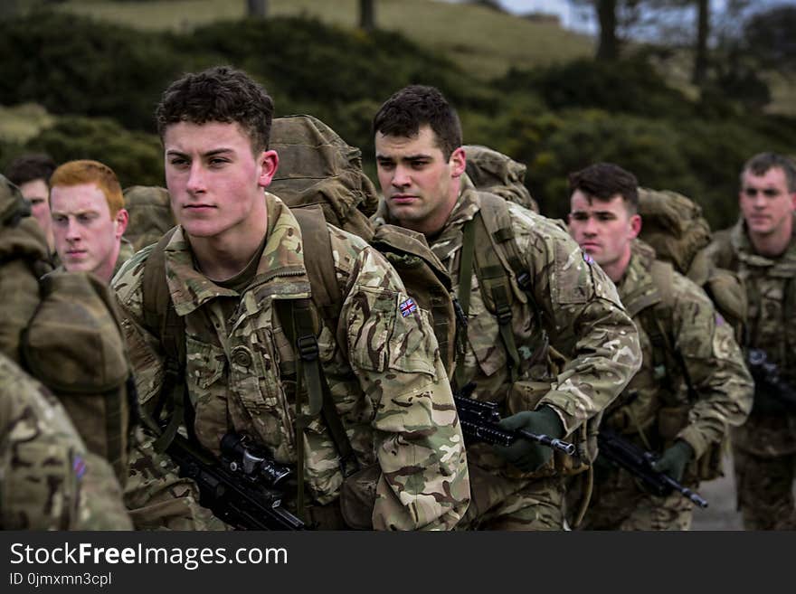 Group of Military Carrying Rifles