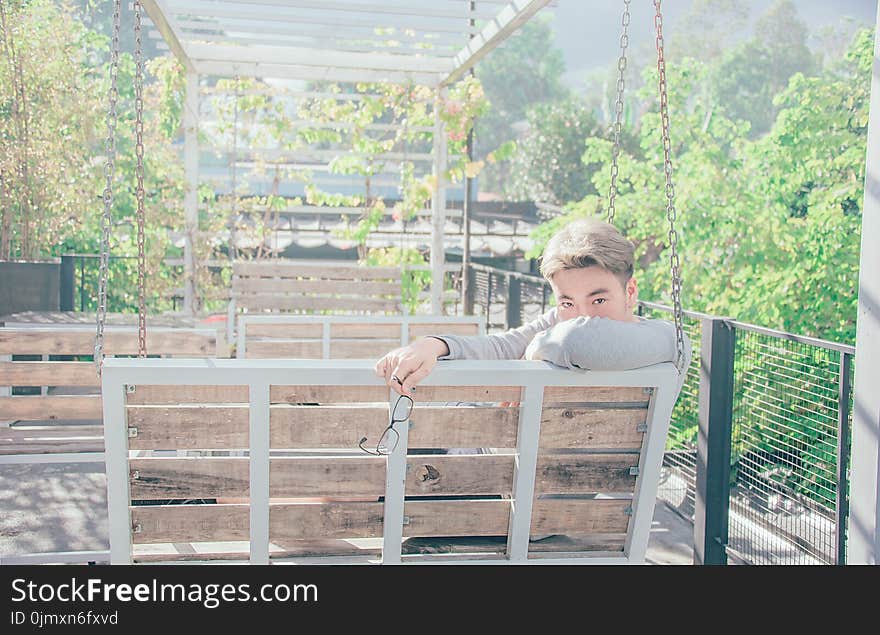 Man in Gray Shirt Sitting on Bench