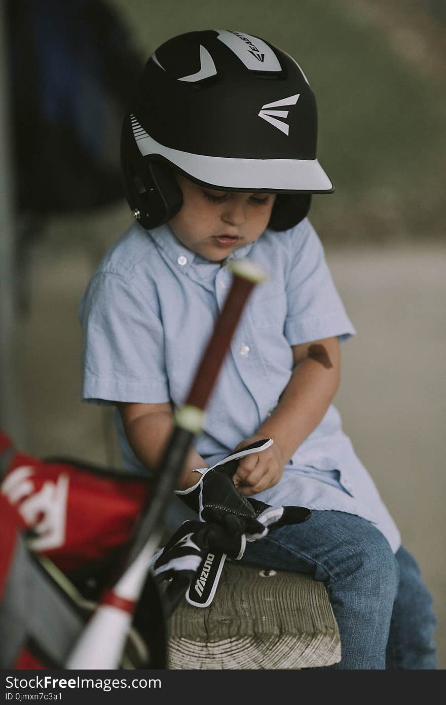 Boy Wearing Black and White Baseball Helmet and Gloves