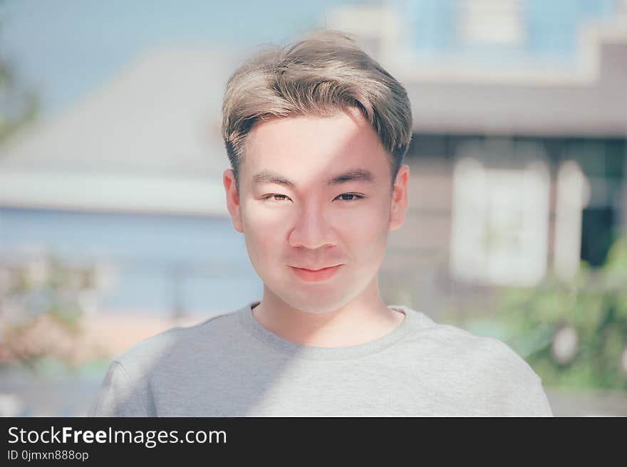 Man in Gray Crew-neck Shirt Smiling on Focus Photo