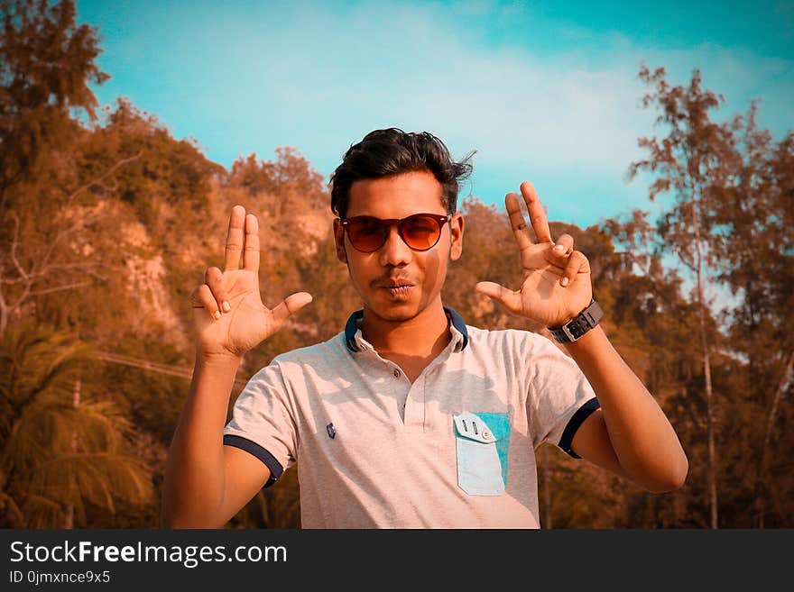 Man Wearing Gray Polo Shirt Near Green Trees