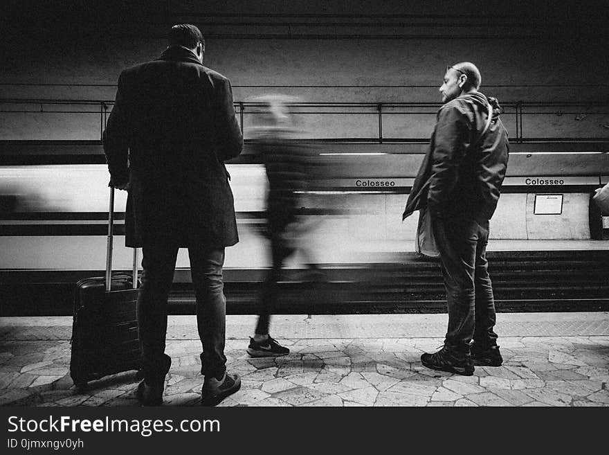 Three Person Standing on Infront of Bullet Train