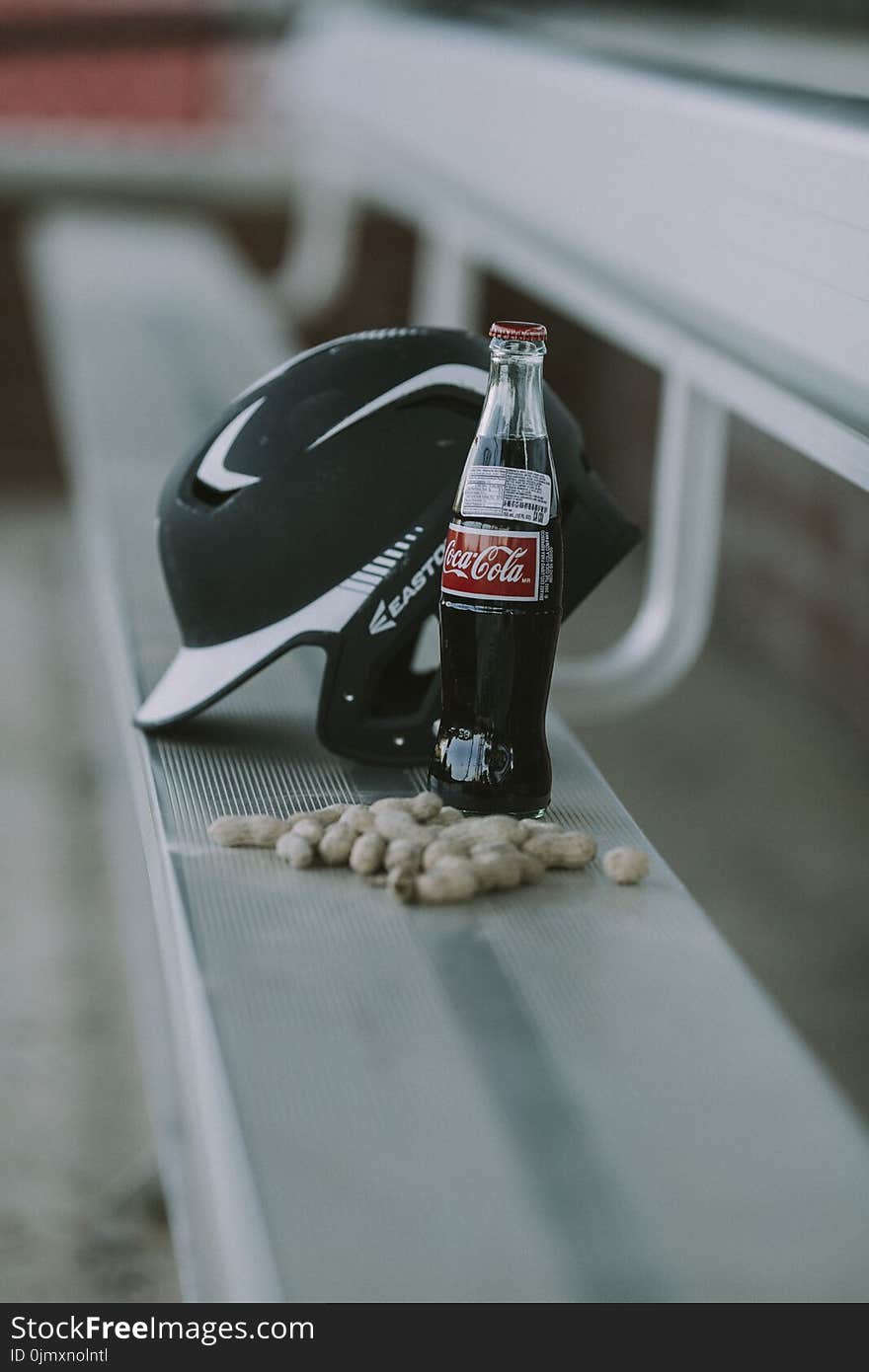 Coca-cola Bottle Beside Black Easton Batting Helmet