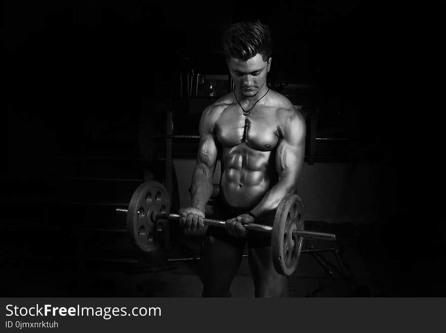 Grayscale Photography of Man Carrying Barbell