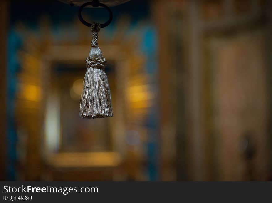 Selective Focus Photograph of Gray Tassel Accessory