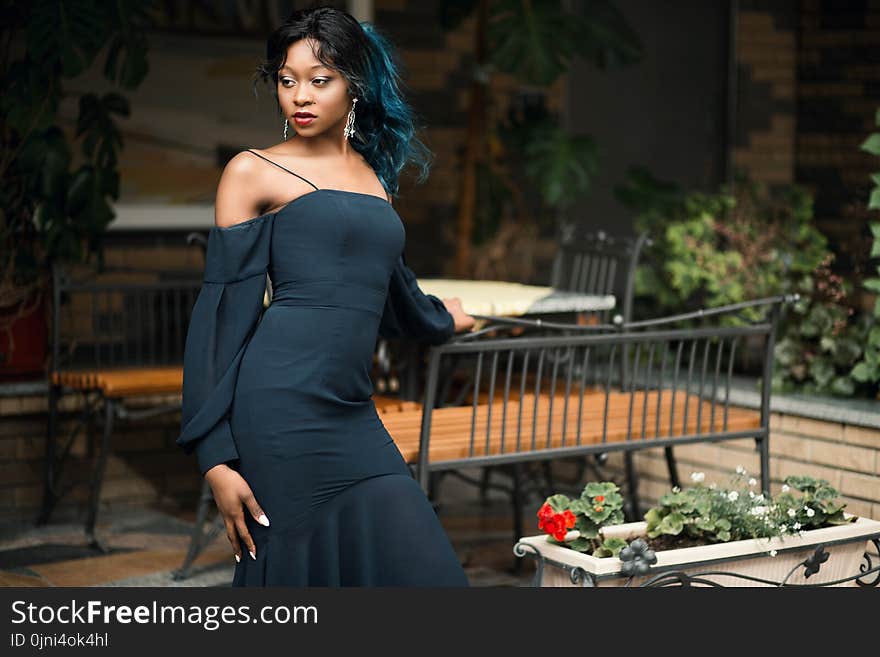 Woman Standing Putting Her Hand on Bench