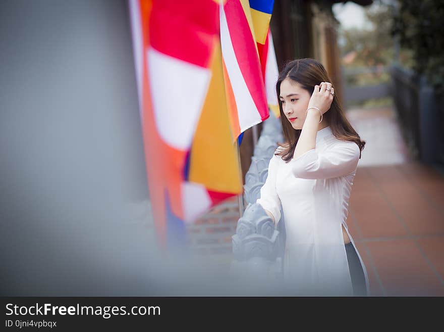 Woman Wearing White Elbow-sleeved Side-slit Dress