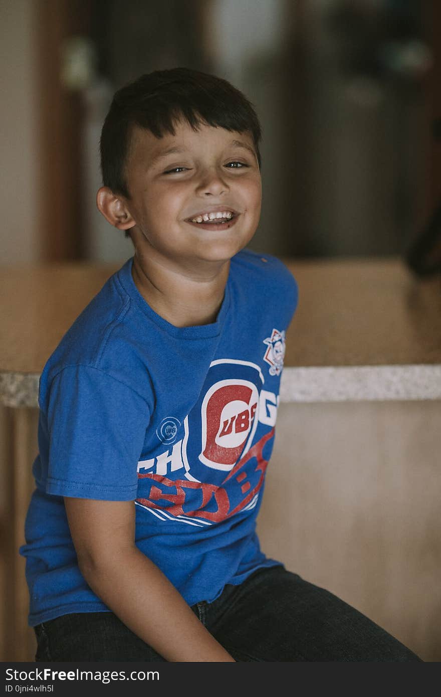 Person Taking Photo of Boy in Blue Chicago Cubs Crew-neck T-shirt in Tilt Shift Photography