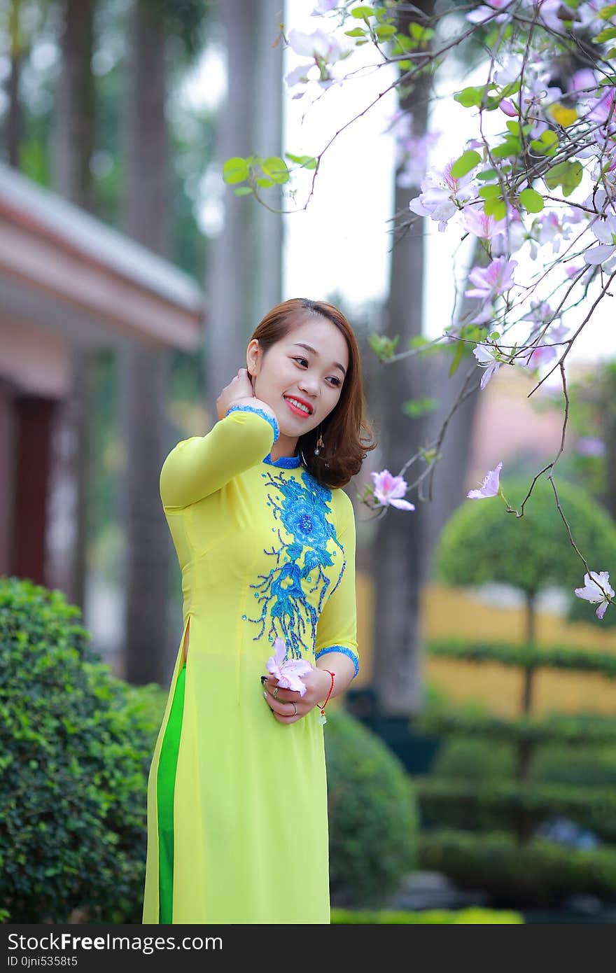 Photo of Woman Wearing Yellow and Blue Floral 3/4-sleeved Dress