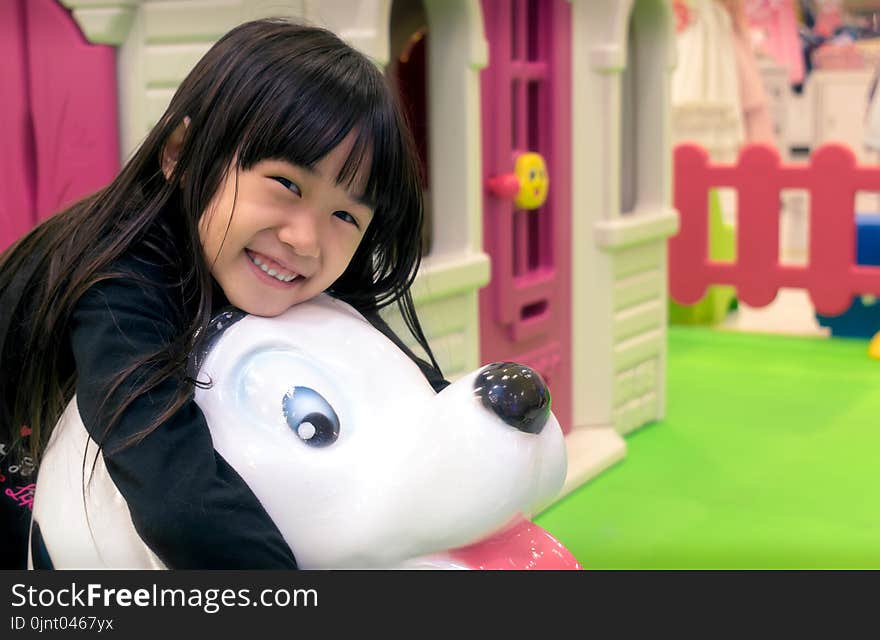 Asian Little Girl Plays in a Indoor Playground.