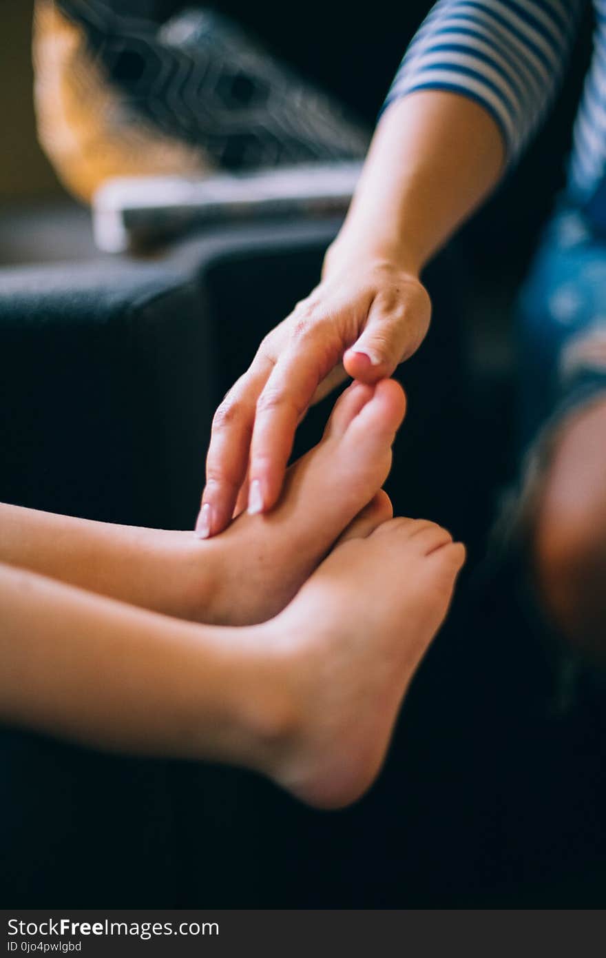 Person Touching Child&#x27;s Feet