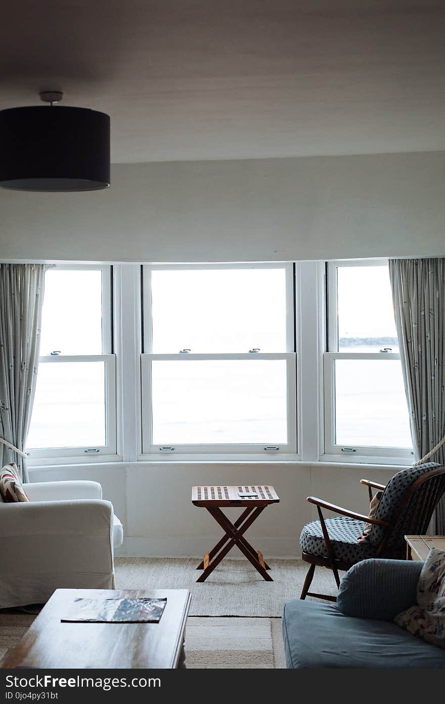 Two Chairs Facing Towards White Casement Window