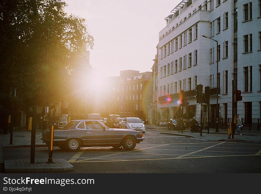 Grey Coupe on Road Near Building