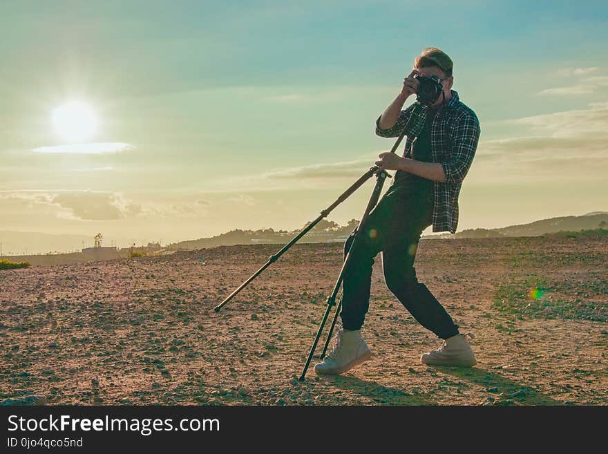 Man Wearing Plaid Sport Shirt Taking a Photo