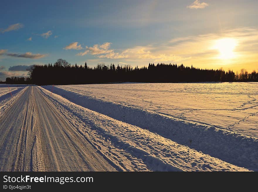 Snow Covered Road during Golden Hour