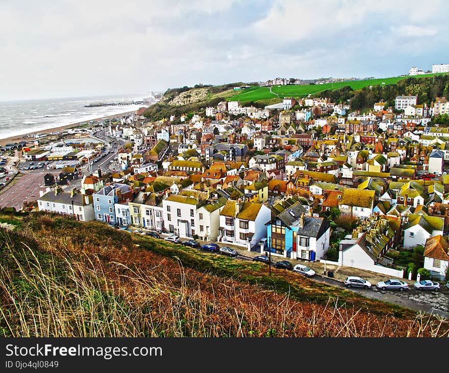 Aerial Photography of Brown Roofed Houses Near Sea