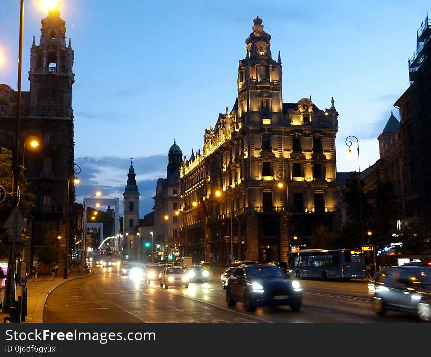 Downtown Budapest Ferenciek tere at sundown in monochrome with car traffic and evening lights in color. Downtown Budapest Ferenciek tere at sundown in monochrome with car traffic and evening lights in color