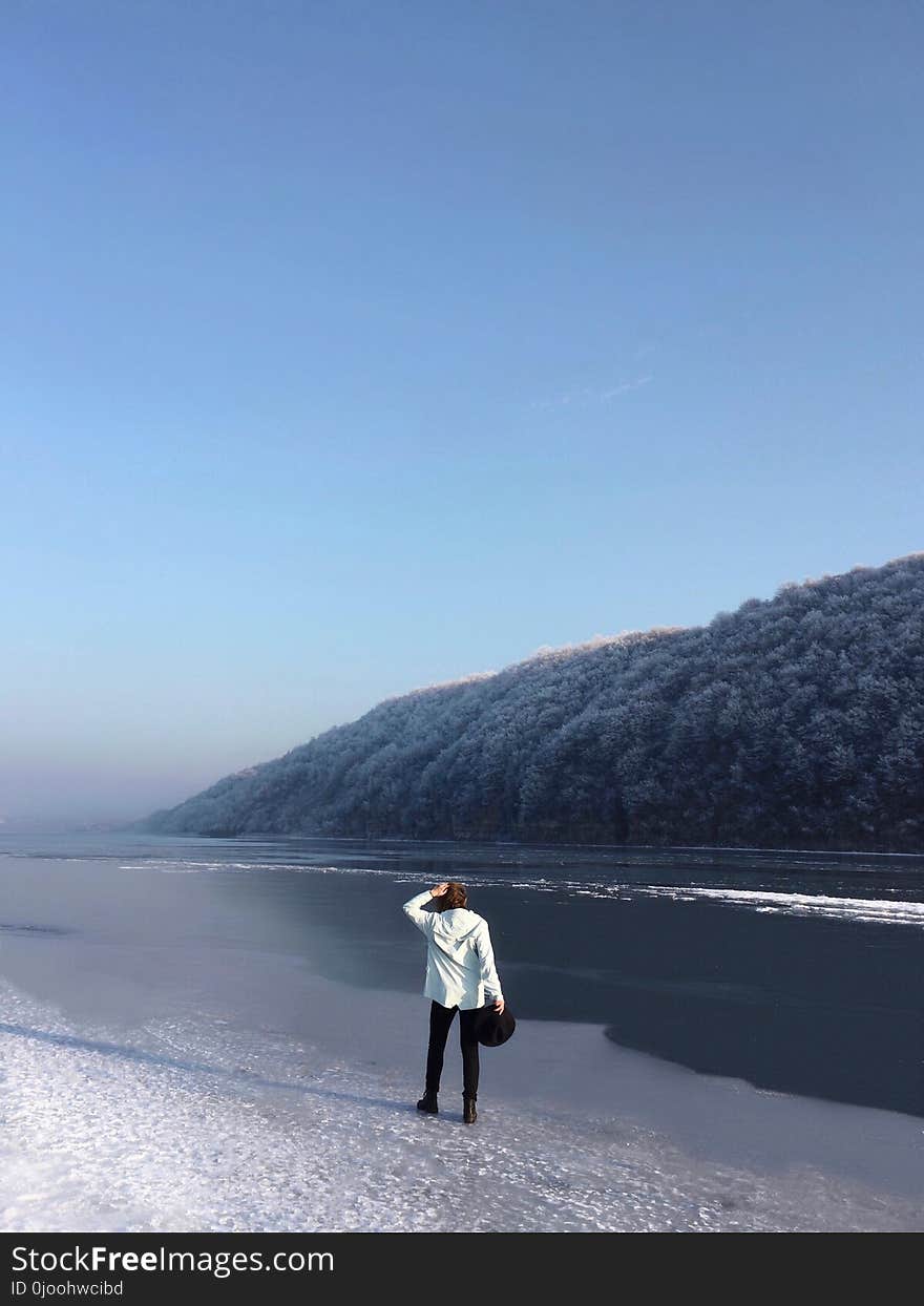 Man Wearing Black Pants Standing on Beach Shore