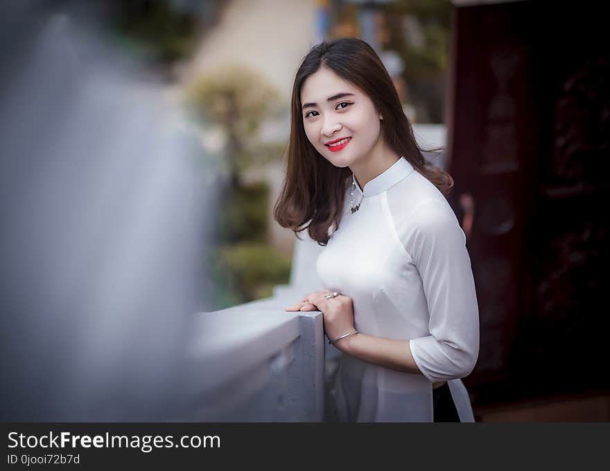 Woman Leaning on Railing