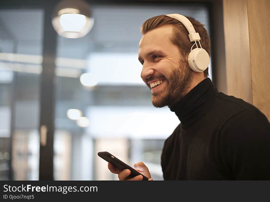 Man Wearing White Headphones Listening to Music