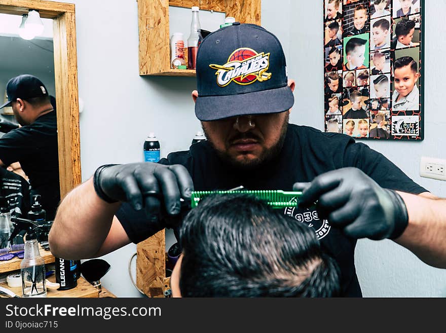 Closeup Photo of Man Wearing Black Shirt Holding Green Comb