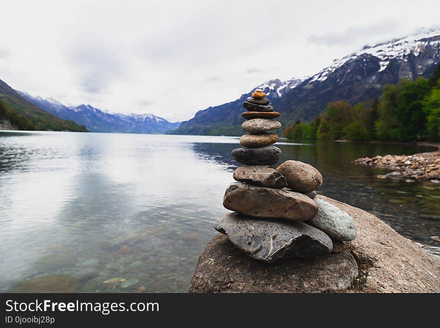 Brown and Gray Stone Stack Near Body of Water