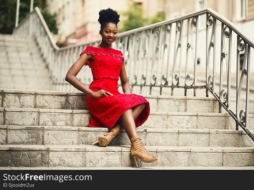 Woman in Red Off-shoulder Dress With Brown Leather High Heeled Gladiator Sandals on Brown Stairs