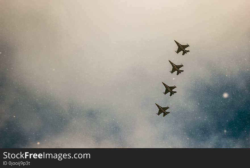 Four Gray Jet Planes on Sky