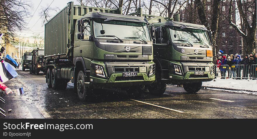 Two Green Dump Trucks on Gray Concrete Road