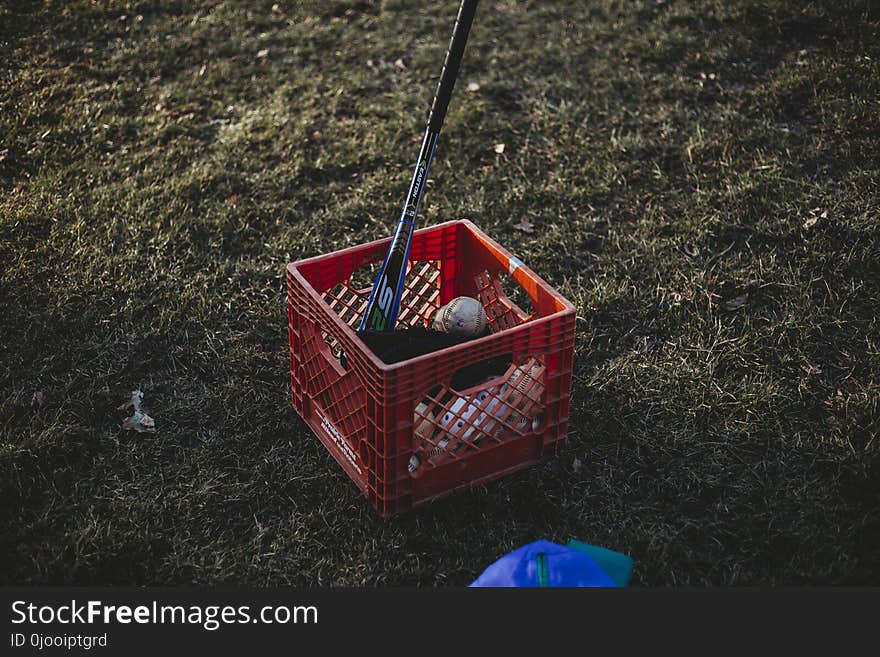 Baseball Bat and Baseball Inside Red Crate