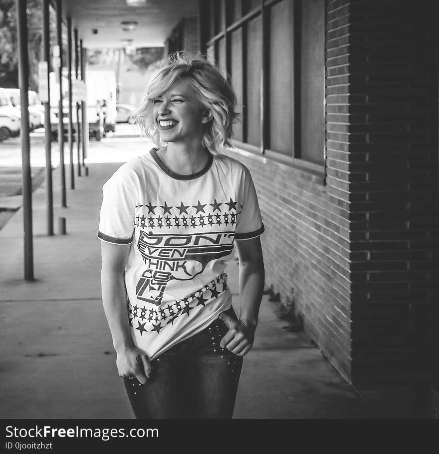 Woman Wearing White Crew-neck Shirt and Denim Jeans