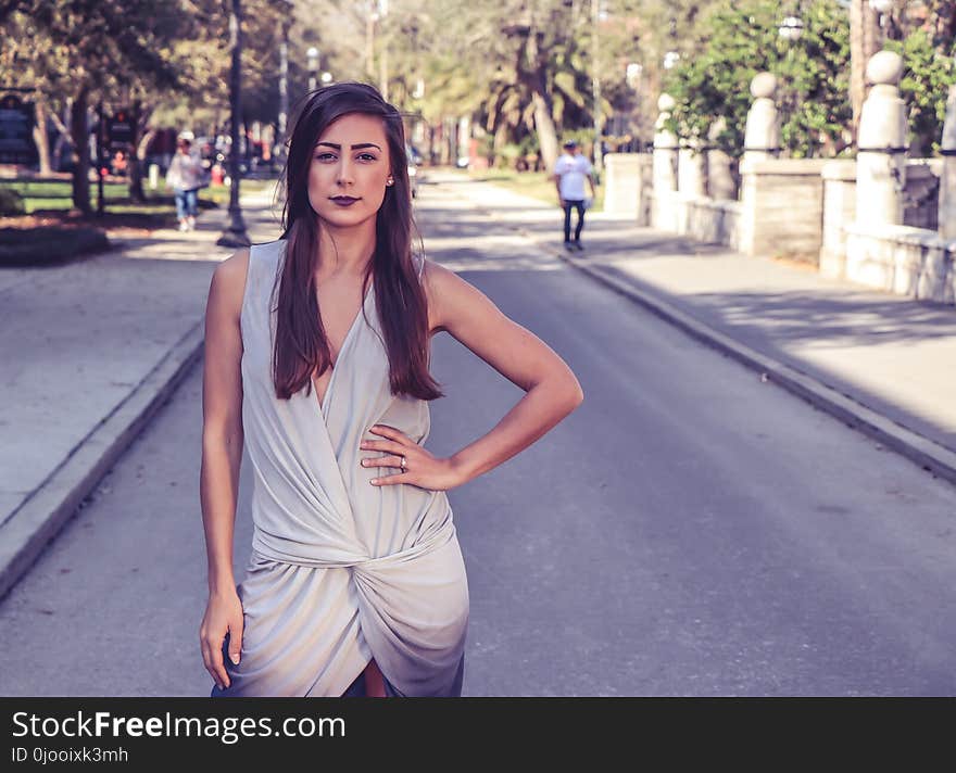 Woman Wearing Gray Sleeveless Slit Dress