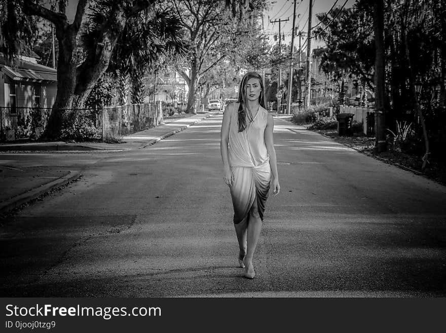 Greyscale Photo of Woman Standing on Street