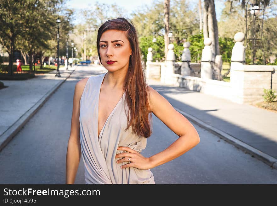 Woman Standing in the Middle of the Street