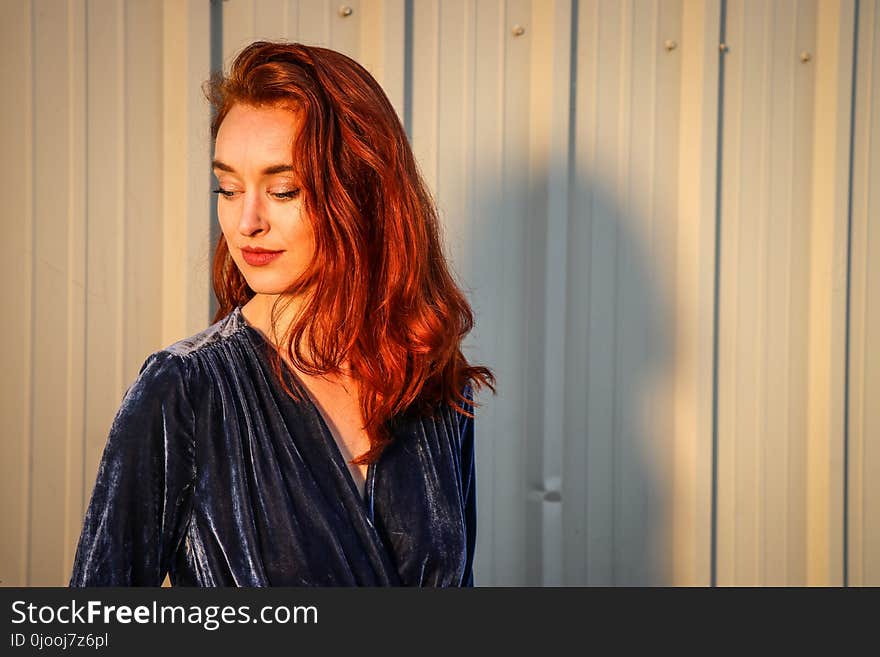 Woman Wearing Blue Top Looking Downward