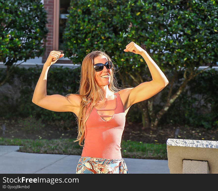 Woman in Pink Tank Top Showing Her Biceps