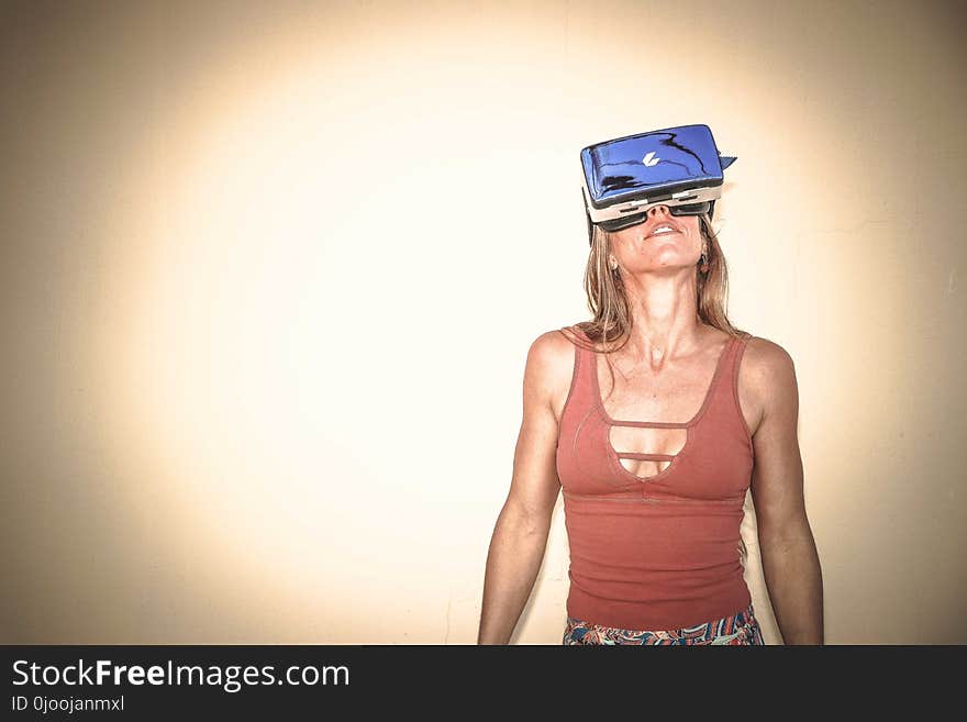 Woman in Brown Cages Sleeveless Top and Blue Virtual Reality Headset