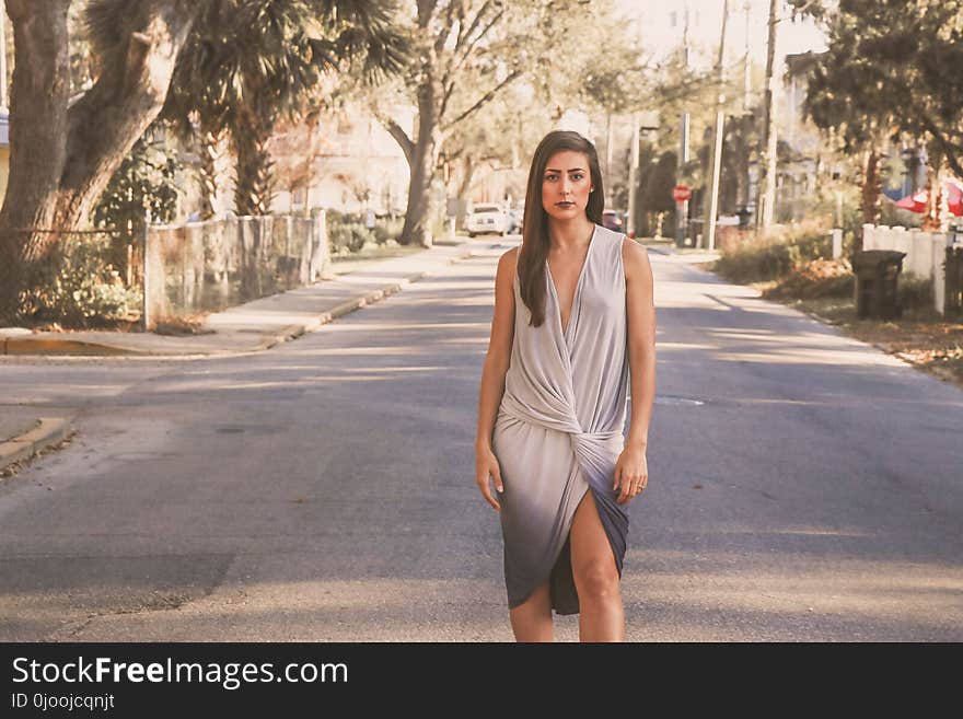 Woman in White and Blue V-neck Sleeveless Wrapped Dress