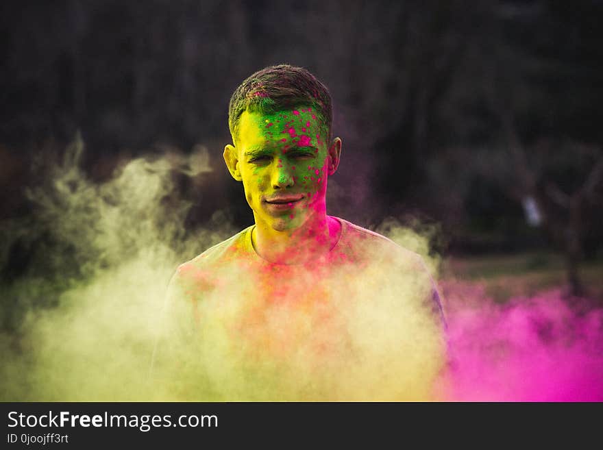 Man Painted With Green and Purple Paints Photo