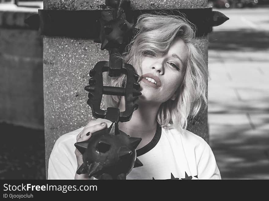 Grayscale Photo of Woman Holding Morning Star