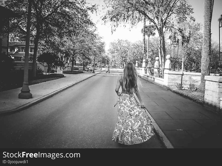 Woman in Floral Dress Standing on Road