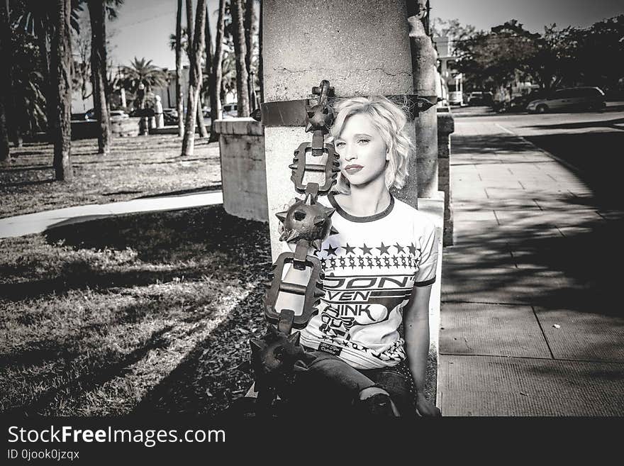 Woman Wearing Crew-neck Shirt Leaning Against the Post