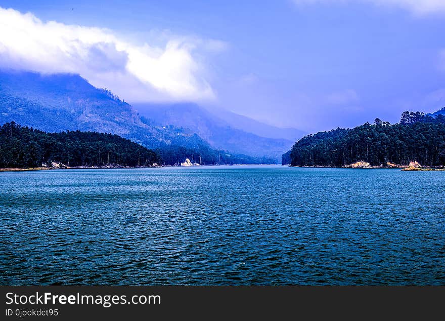 Body of Water Under Blue and White Sky