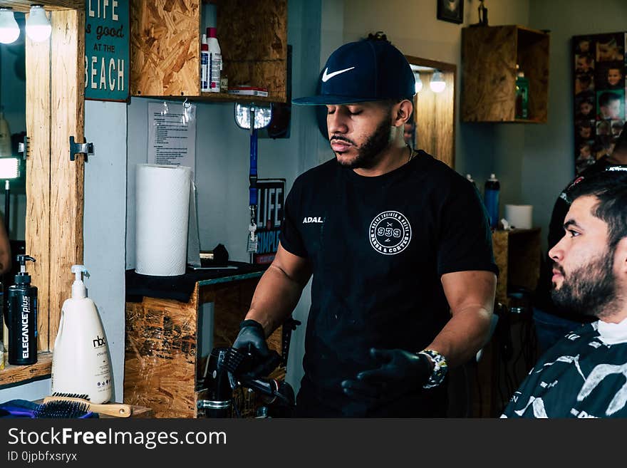 Man Wearing Black Shirt Standing Near Man Wearing Gray Shirt Inside Room