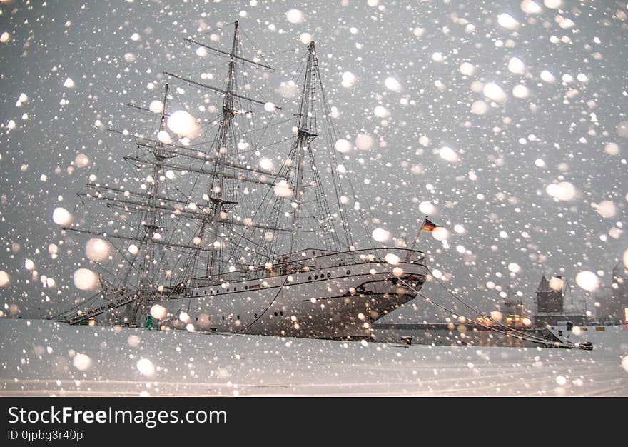 White Sailing Ship Docked at Pier