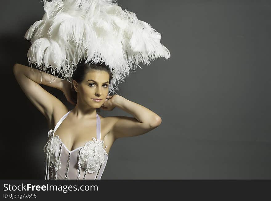 Woman in White Headdress and White Mesh Top