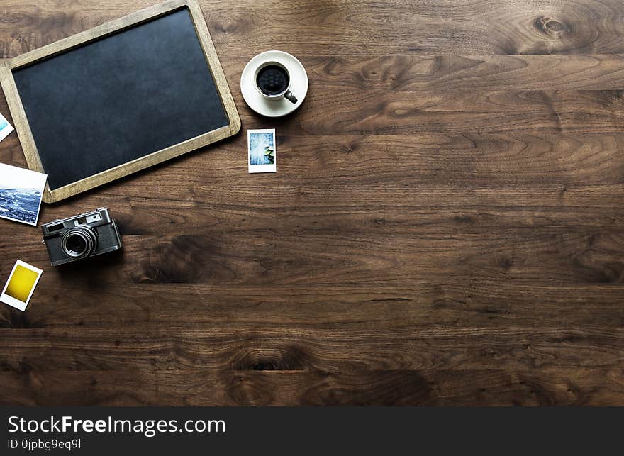 Photography of Tray, Coffee Cup and Camera on Table Top