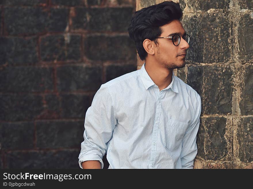 Man in Blue Sports Shirt Wearing Eyeglasses