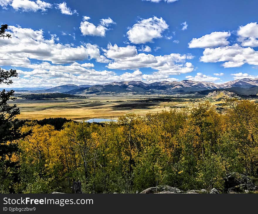 Landscape Photography of Grass Land and Mountains