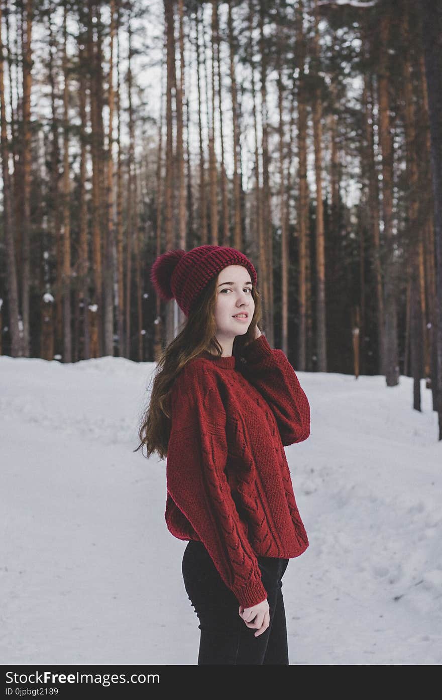 Woman Wearing Red Sweater and Red Beanie Under Forest